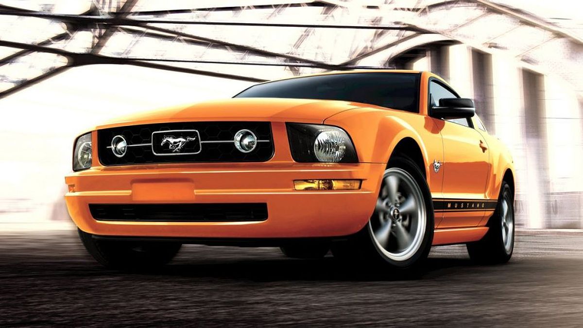 2009 Ford Mustang in Grabber Orange Clearcoat under a bridge