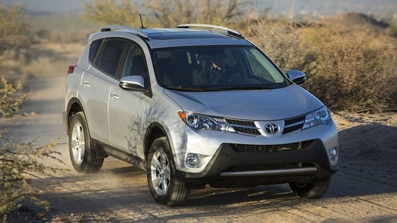 2013 Toyota RAV4 driving down a dirt road