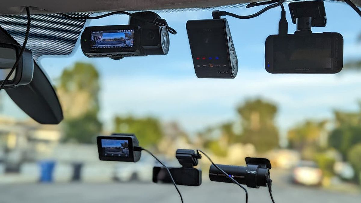 A variety of dash cams set up on a car windshield